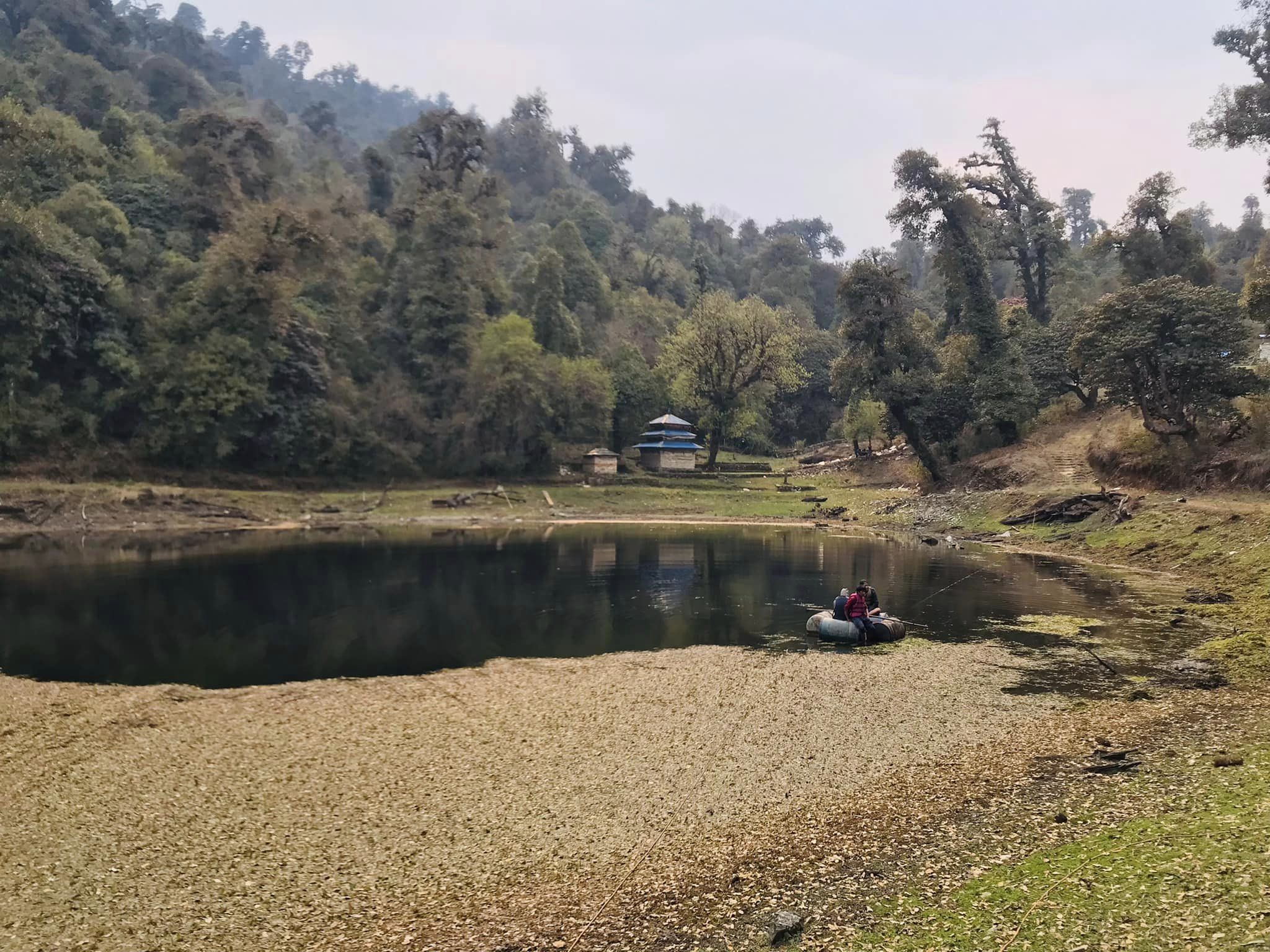 Locals cleaning the weed-covered Paryvarani lake